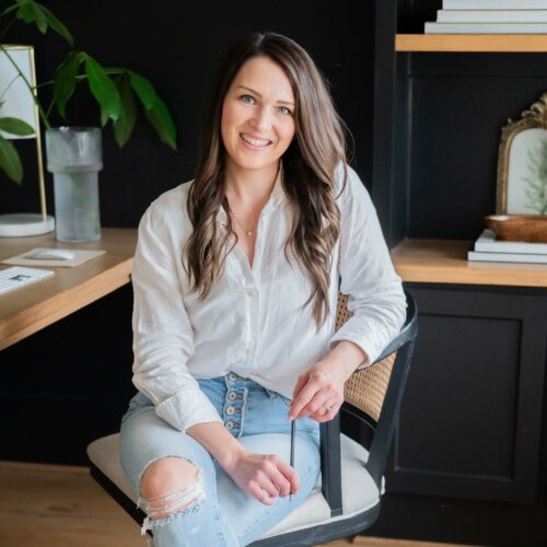 Stephanie O'Keefe, SEO strategist and WordPress designer sitting at desk wearing a white shirt in Raleigh, NC.