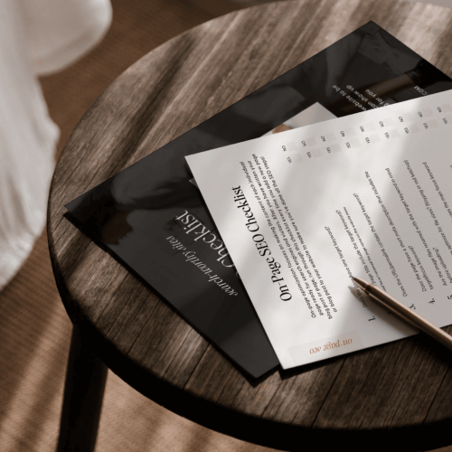 On page seo checklist printable on wood desk in home office.