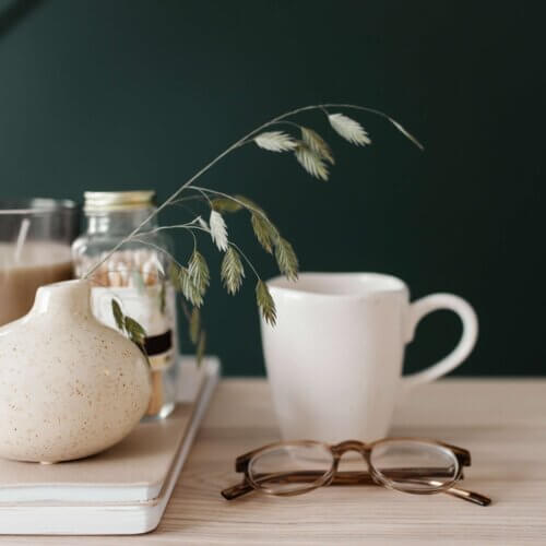 haute stock stock photo of modern office desk at home with glasses, coffee and plant.