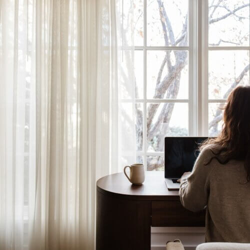 working at home on FG funnels and wordPress website on computer