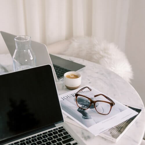 image of laptop at home office with glasses