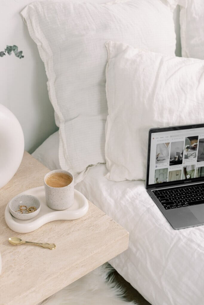 Computer With Products On Wordpress Website Next To Bed