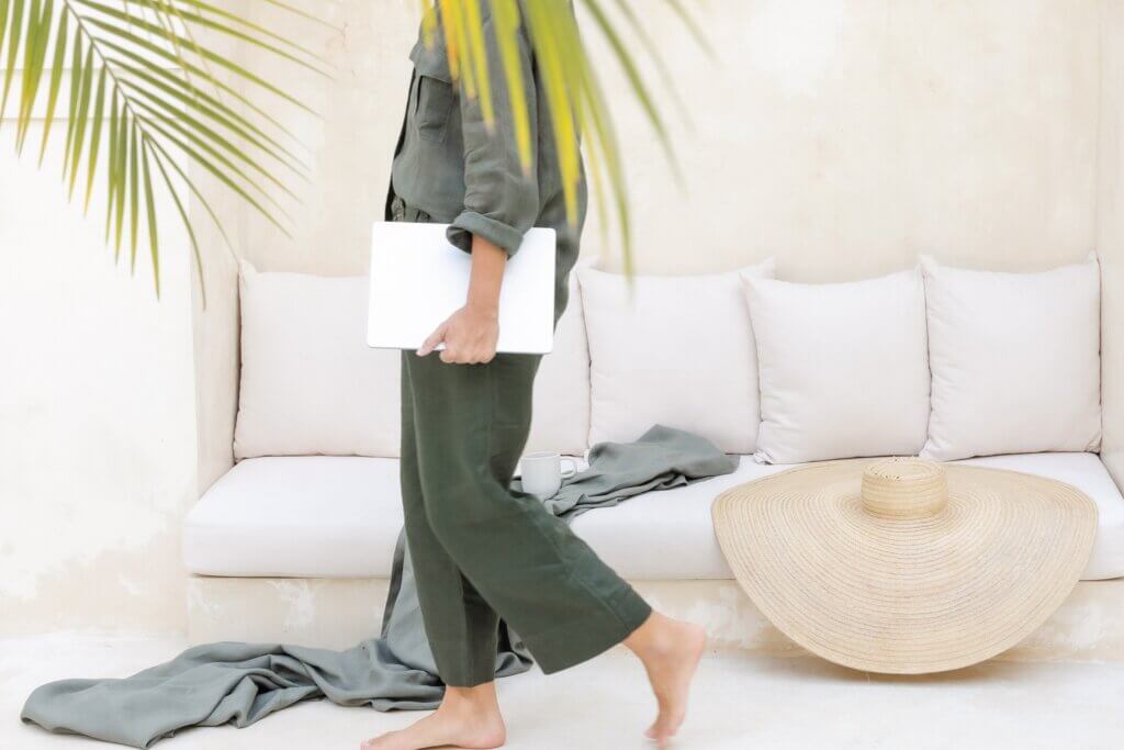 Travel Agent Holding Laptop And Walking While On Vacation