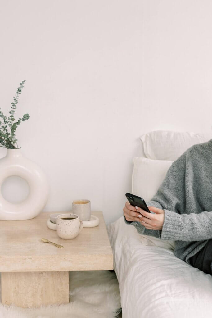 Business Owner Reading Phone In Bed