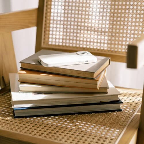 stack of interior design books on cane chair