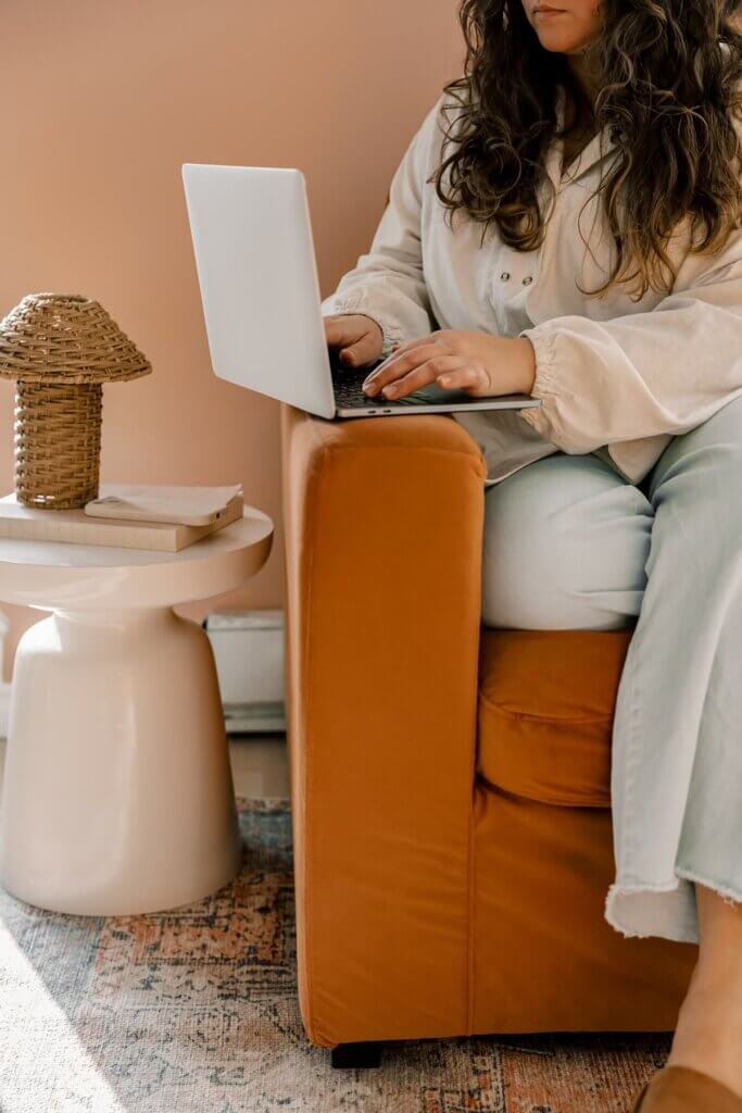 Business Owner Typing At Home On Laptop