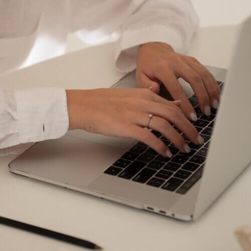 business owner, typing on computer