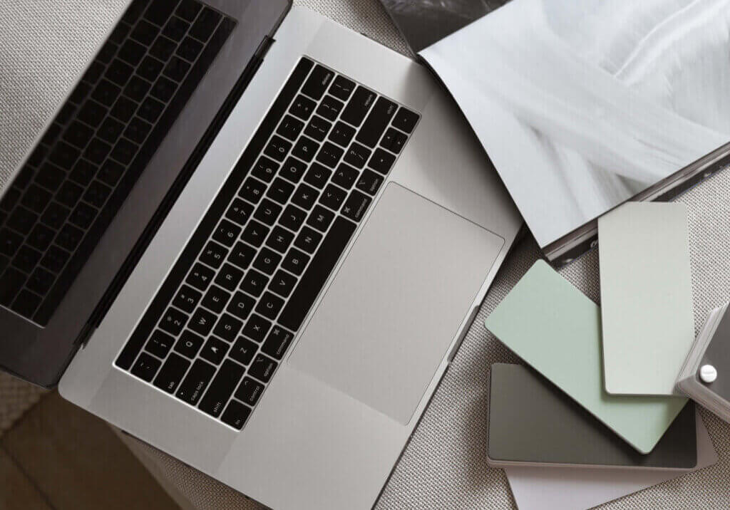 laptop with color samples in front of it
