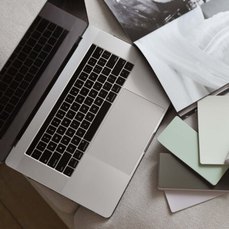 laptop with color samples in front of it