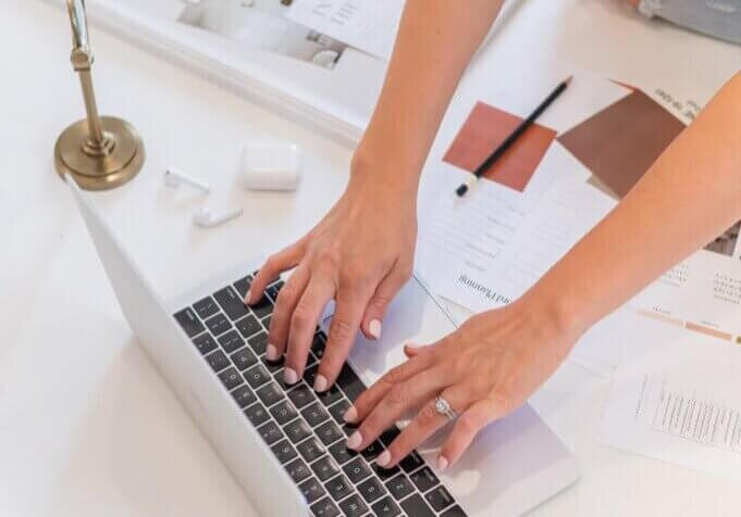 Southern Creative owner, Stephanie O'Keefe typing on Computer adding a contact form in WordPress