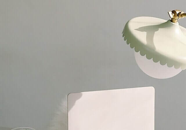 laptop, airpods, and green latte on desk.