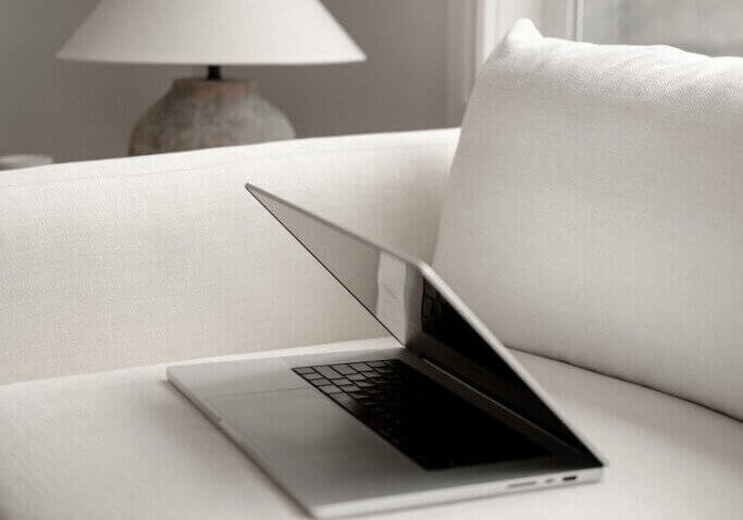 computer on white couch in interior design studio