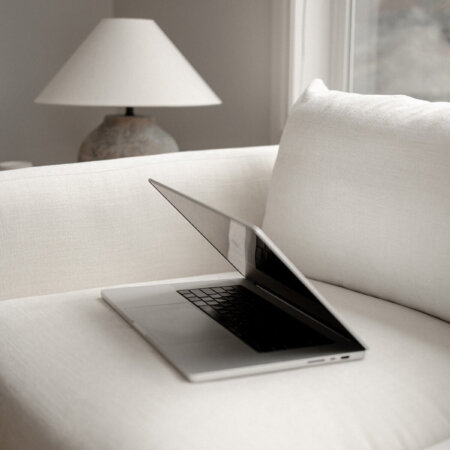 computer on white couch in interior design studio