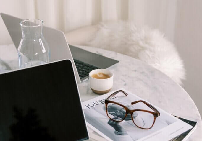 image of laptop at home office with glasses