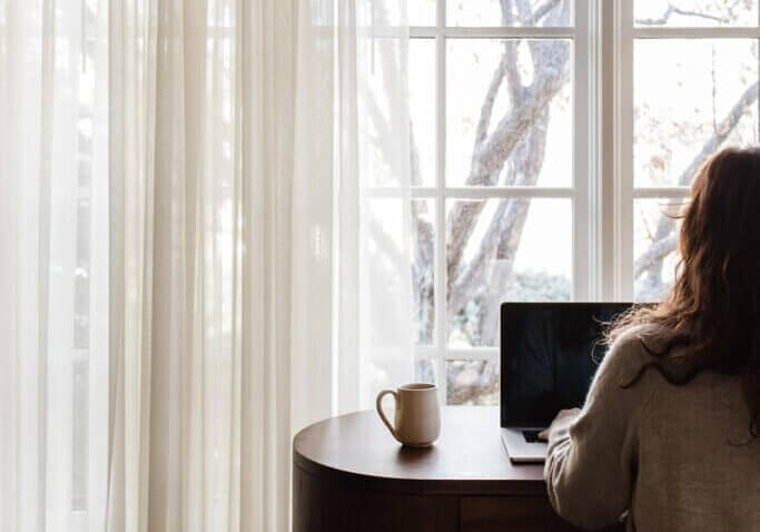 working at home on FG funnels and wordPress website on computer