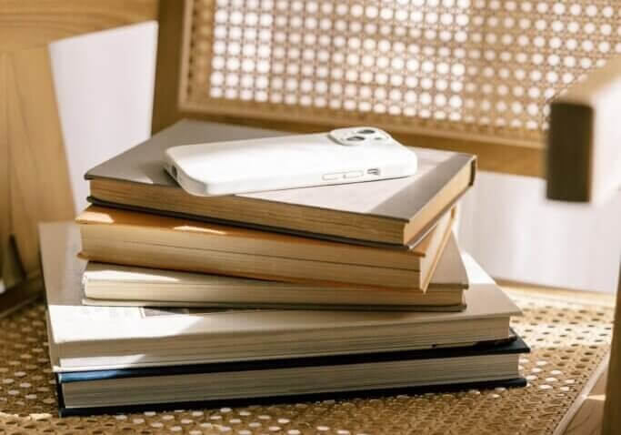 stack of interior design books on cane chair