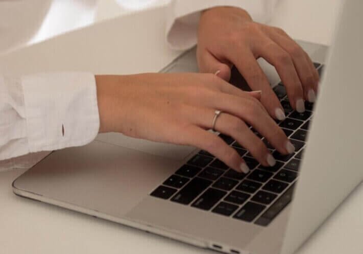 business owner, typing on computer