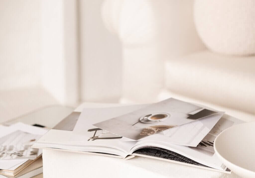 interior designer at home studio with pile of papers working on seo for interior designers