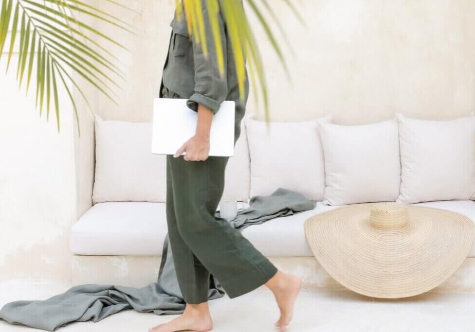 travel agent holding laptop and walking while on vacation