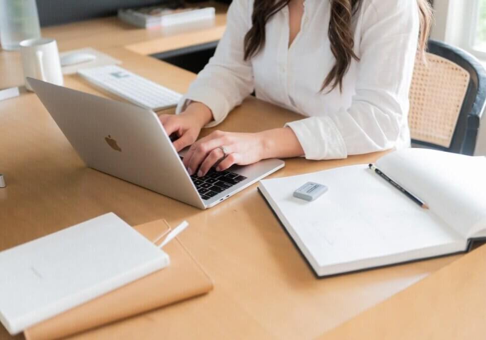 seo strategist, stephanie okeefe, typing on computer in home office in Raleigh, NC.