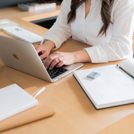 seo strategist, stephanie okeefe, typing on computer in home office in Raleigh, NC.