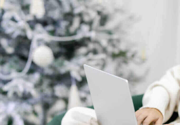 web designer reviewing 2023 sitting next to christmas tree