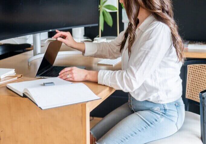 WordPress and SEO Strategy company owner, Stephanie O'Keefe, sitting at desk in Raleigh, NC.