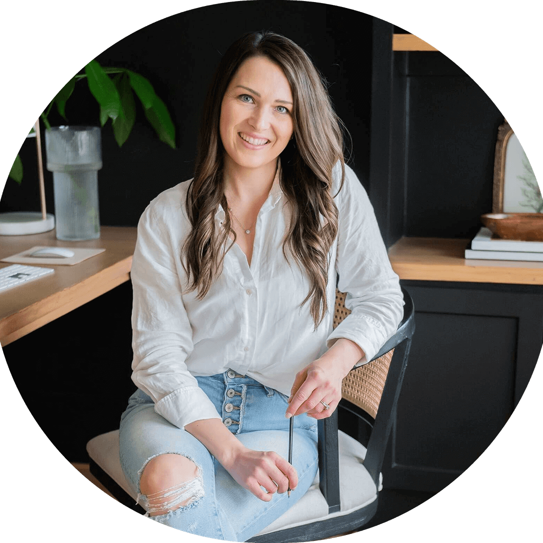 Steph O'Keefe, SEO strategist and WordPress designer sitting at desk wearing a white shirt in Raleigh, NC.