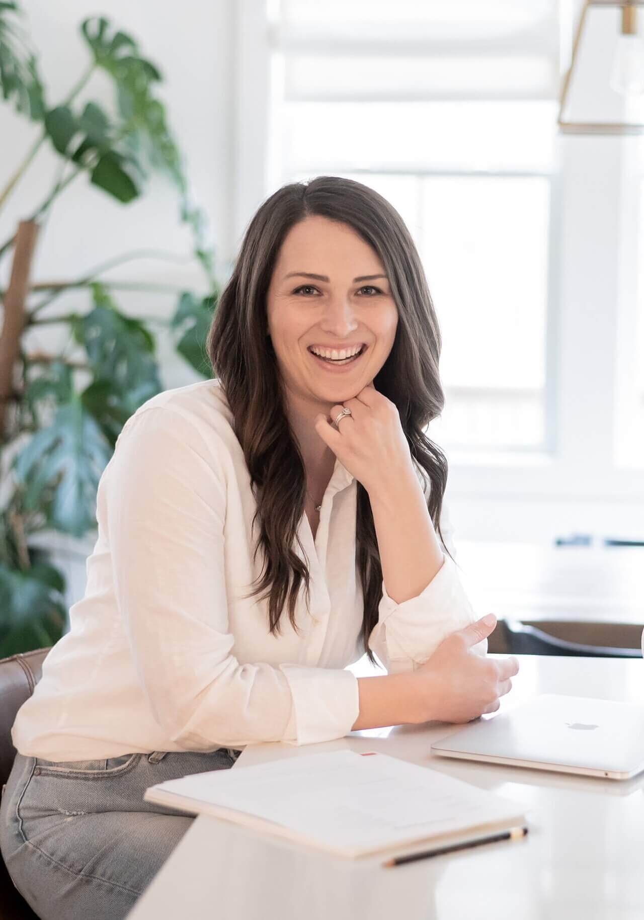 Seo Strategist And Website Designer, Stephanie Okeefe Sitting At Home Office In Raleigh Kitchen.