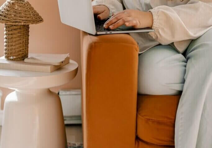 business owner typing at home on laptop