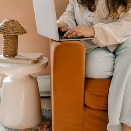business owner typing at home on laptop